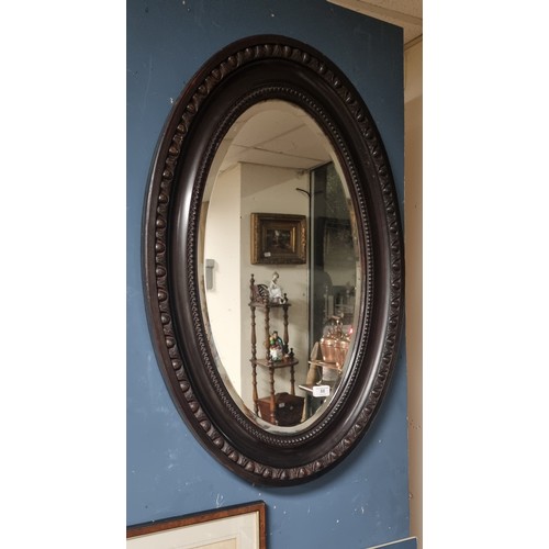 88 - Edwardian Walnut Finish Oval Mirror, carved and moulded oval frame. H:88 x W:60cm