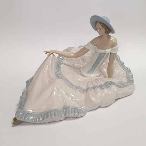 45 - Large Nao Porcelain Figure, Girl Seated wearing hat.  H:19 x W:32 x D:20cm