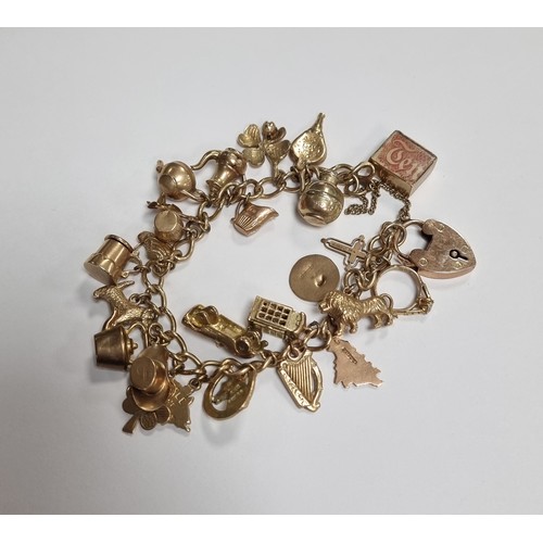 819 - Charm Bracelet (total Weight 38.2g) 9ct Gold Clasp and many charms with 9ct gold markings.