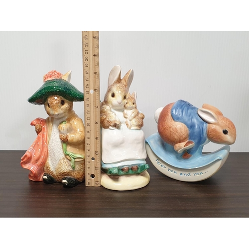 921 - Two Enesco Beatrix Potter figures and an Enesco Peter Rabbit moneybox. Largest 19cm tall