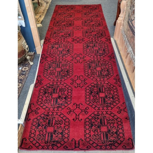 10 - Rich Red Ground Turkmen Handwoven Runner with a large Bokhara Elephant Foot Design, 305cm x 100cm