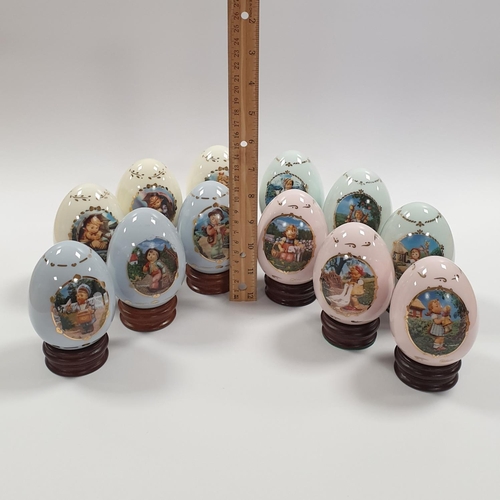 136 - Set of 12x M.J. Hummel Danbury Mint Porcelain Egg Collection on Stands. Height 10cm