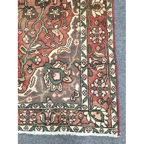 65 - Washed Red-Ground Handwoven Village Rug with Floral Medallion Design, 200cm x 135cm