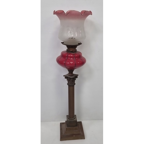 89 - Antique Cranberry glass column oil lamp, H: 76cm