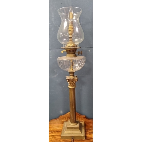 88 - Brass-finish column table lamp with glass reservoir and shade H:75cm x W:17cm.