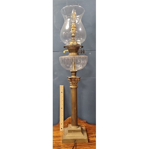 88 - Brass-finish column table lamp with glass reservoir and shade H:75cm x W:17cm.