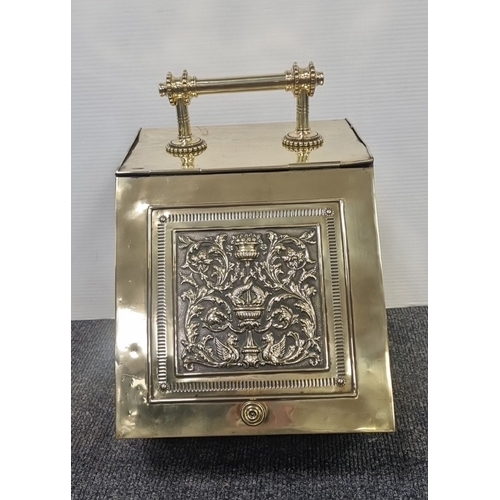 220 - Brass slope front coal scuttle with embossed classical panel and handle H:40cm x W:29cm x D:40cm.
