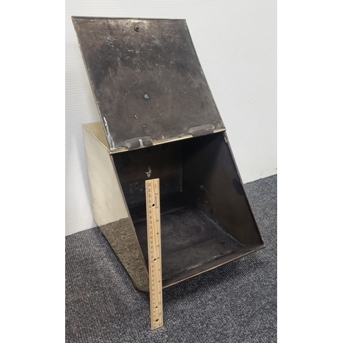 220 - Brass slope front coal scuttle with embossed classical panel and handle H:40cm x W:29cm x D:40cm.