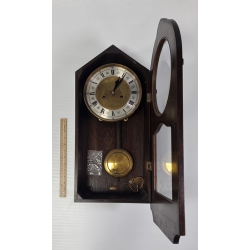 227 - Carved wooden wall clock with pendulum and key, H: 61cm x W: 31cm x D: 15cm