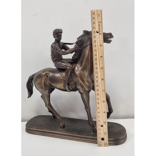 236 - Signed bronze-effect racehorse and jockey figure on oval base