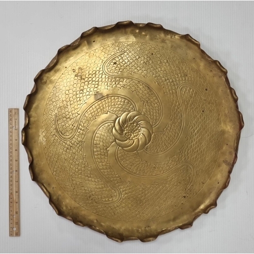 11 - Large Brass charger with chased rosette and scroll decoration, Diameter: 54cm.