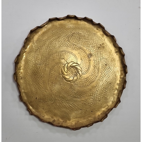 11 - Large Brass charger with chased rosette and scroll decoration, Diameter: 54cm.
