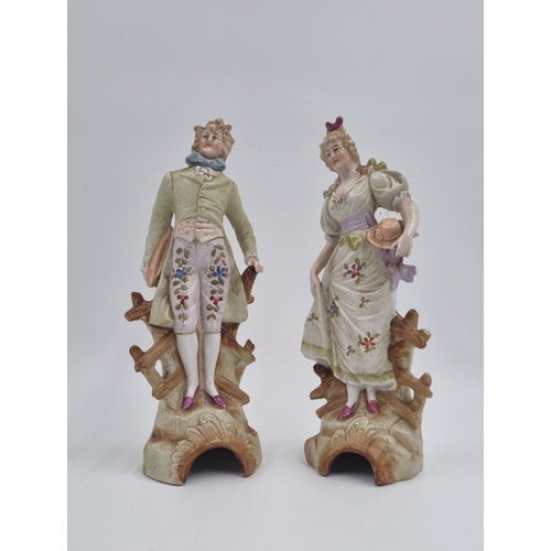 20 - Pair of porcelain figural statues, H: 24cm.