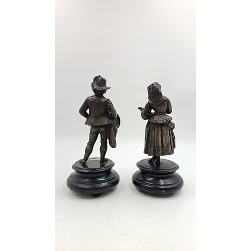23 - Pair of patinated metal figures on plinths