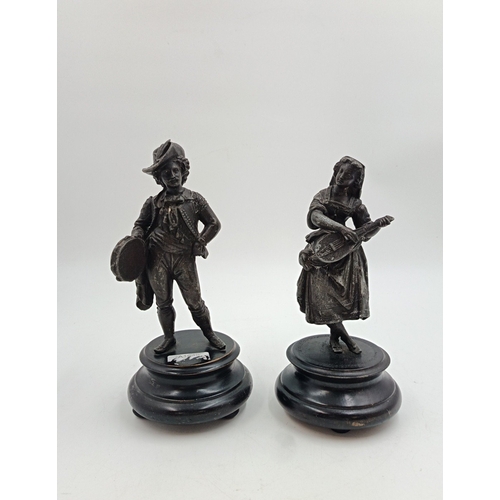 23 - Pair of patinated metal figures on plinths