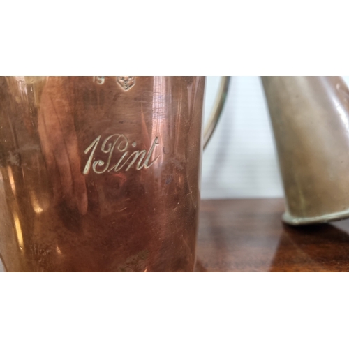 58 - Collection of copper and brass vessels, including a horn and measures (one engraved ‘1 Pint’) H: 16c... 