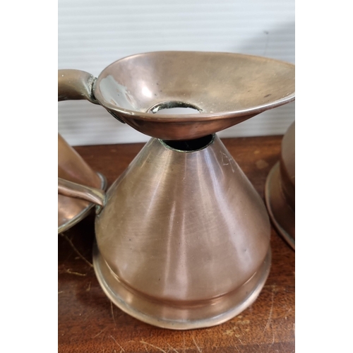 58 - Collection of copper and brass vessels, including a horn and measures (one engraved ‘1 Pint’) H: 16c... 