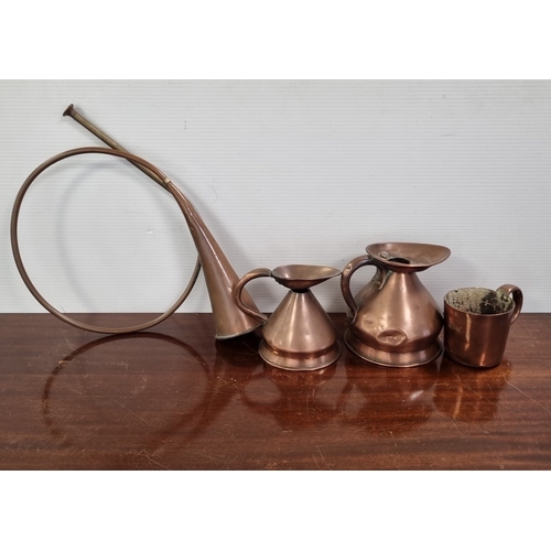 58 - Collection of copper and brass vessels, including a horn and measures (one engraved ‘1 Pint’) H: 16c... 