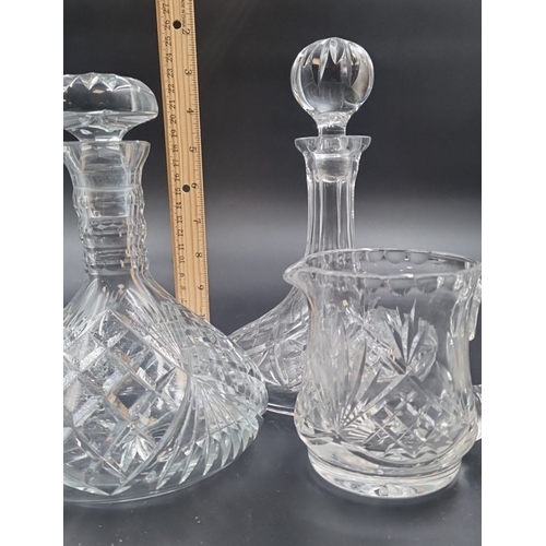 86 - Lot of three cut crystal pieces including 2x ships decanters and 1 jug H: 25cm.