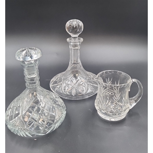 86 - Lot of three cut crystal pieces including 2x ships decanters and 1 jug H: 25cm.