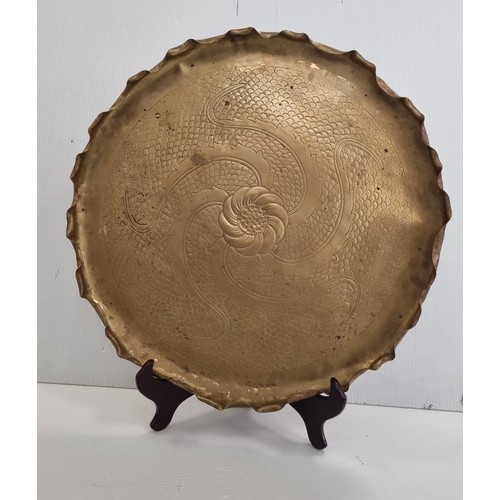 11 - Large Brass charger with chased rosette and scroll decoration, Diameter: 54cm.
