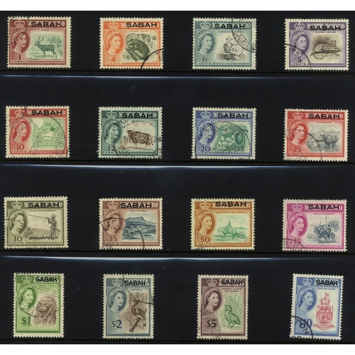 114 - BRUNEI, NORTH BORNEO, SARAWAK & MALAYA collection of VFU sets or short sets housed on black leaves i... 