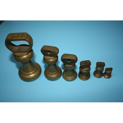 920 - Set 6 brass weights tallest 3 1/2