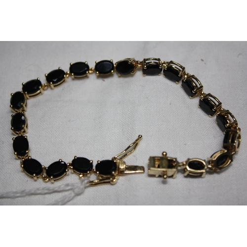 1065 - Silver gilt stone set line bracelet