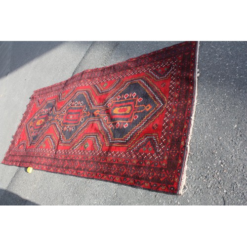 1904 - Red ground rug with central 