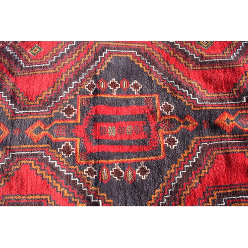 1904 - Red ground rug with central 