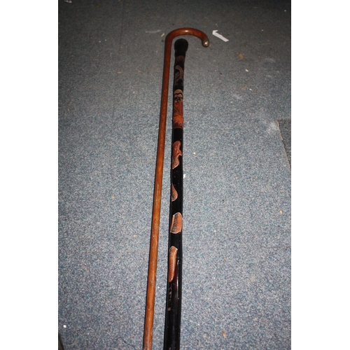 1100 - Carved Oriental walking stick & silver capped walking stick