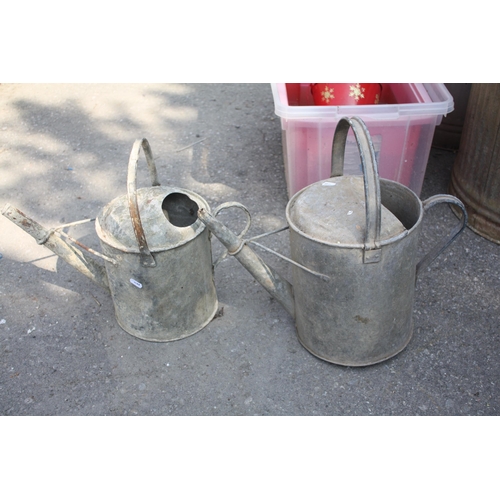 266 - Galvanised watering can & 1 other- both with wire supports