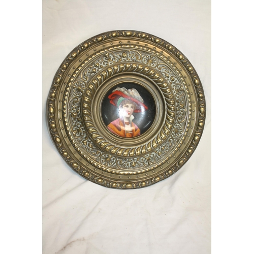 502 - Circular china portrait plaque with old repair to rear set in wide brass frame 13 1/2