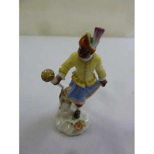 115 - A Meissen blackamoor figurine carrying a baton, 7cm (h)