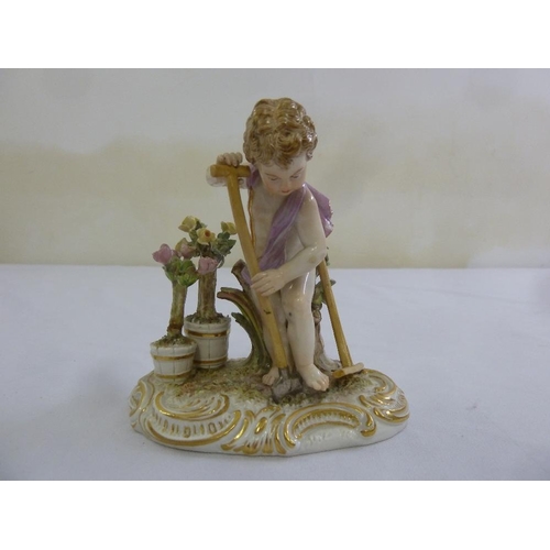 119 - A Meissen figurine of a child with a spade on raised oval base, marks to the base, 13cm (h)