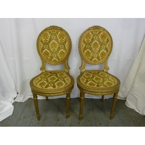 18 - A pair of French gilt wood upholstered boudoir chairs on four cylindrical legs