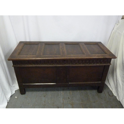 7 - A rectangular oak coffer with hinged panelled cover on four rectangular legs