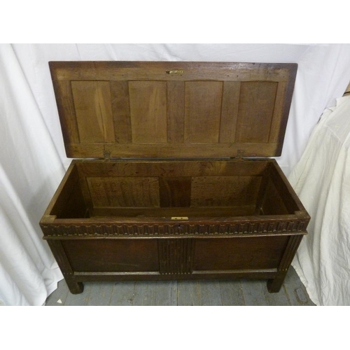 7 - A rectangular oak coffer with hinged panelled cover on four rectangular legs