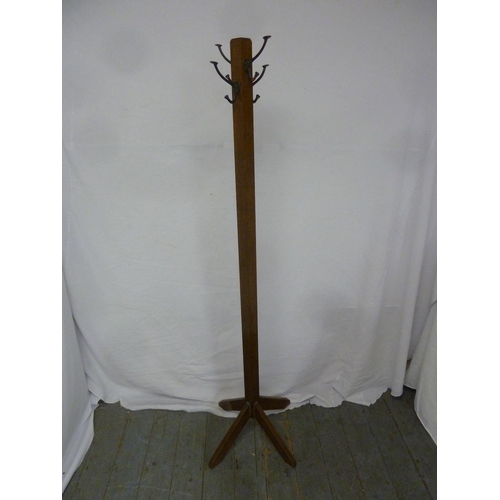 25 - A mahogany hat and coat stand on three angled legs