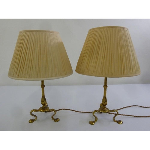 35 - A pair of brass antique lamps on three scroll legs with silk shades