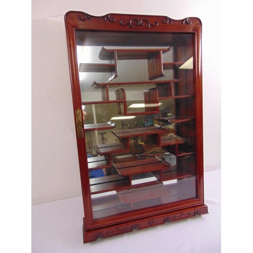 12 - A wall mounted Oriental style miniatures display cabinet with mirrored back