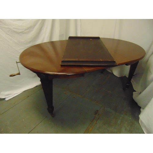 16 - A Victorian shaped oval mahogany dining table with two drop in leaves and Joseph screw mechanism, by... 