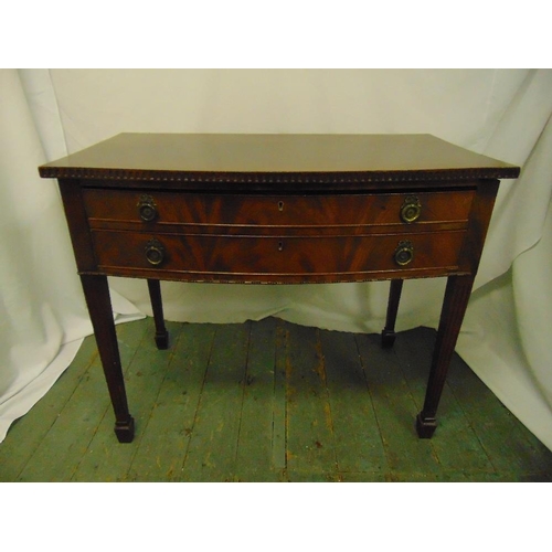 4 - A rectangular mahogany two drawer table with brass handles on tapering rectangular legs