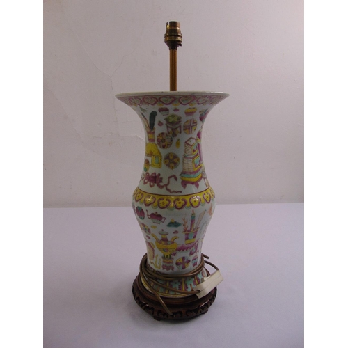 50 - An early Chinese porcelain table lamp decorated with stylised leaves and furniture on carved hardwoo... 