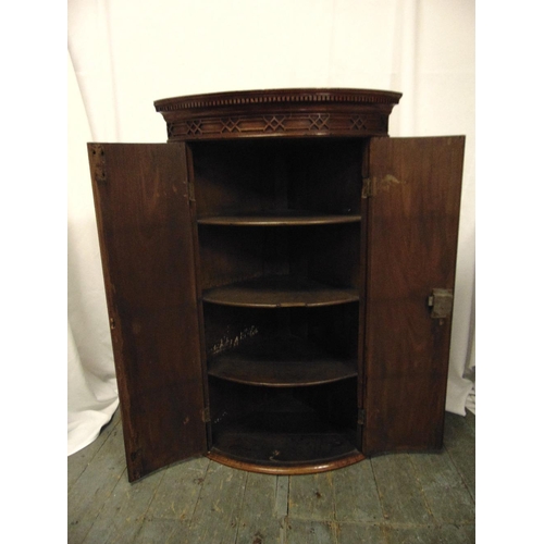 8 - A 19th century mahogany inlaid wall mounted corner cabinet with hinged doors