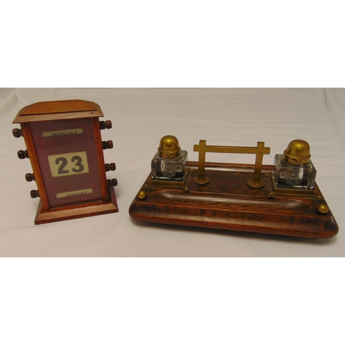 180 - An early 20th century rectangular oak inkstand, the two detachable glass inkwells with hinged brass ... 