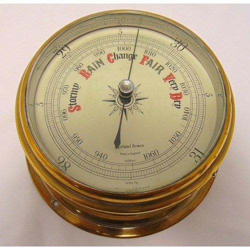 187 - A wall mounted brass barometer, circular with white enamel dial, 18cm diameter