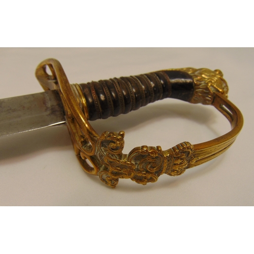 227 - An early 19th century military officer dress sword in brass and leather scabbard with engraved blade... 