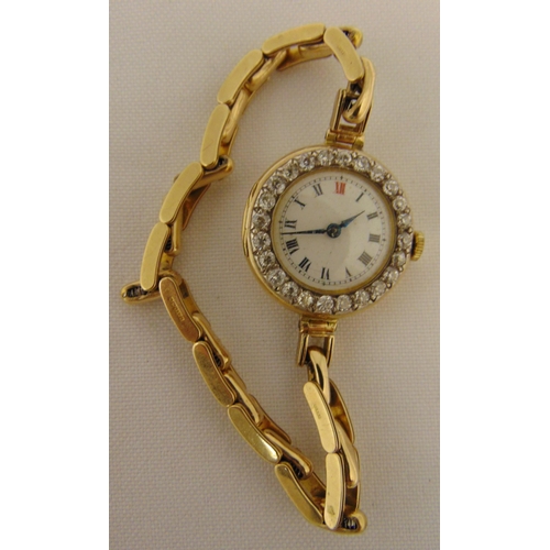 266 - 18ct yellow gold ladies wristwatch with a diamond bezel on a gold plated bracelet