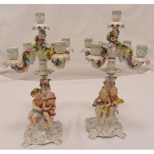 95 - A pair of Sitzendorf five light candelabra the figural stems representing the four seasons and suppo... 